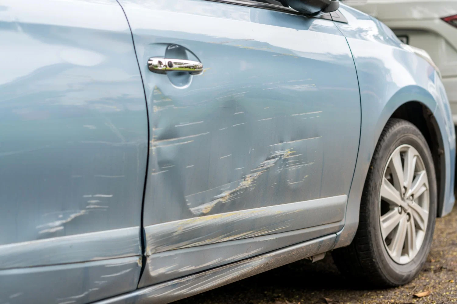 Professional auto paint and body damage repair work in progress at collision center